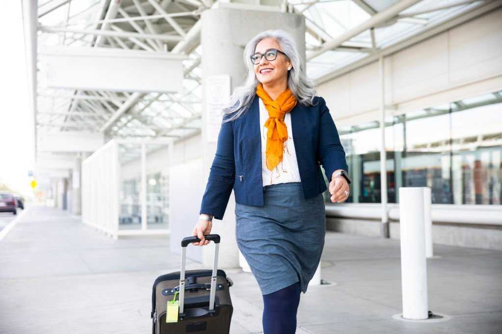 Senior Hispanic Woman looking for the right airline